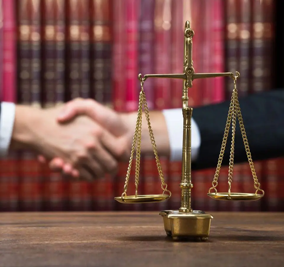 A judge 's gavel and scale on top of a table.